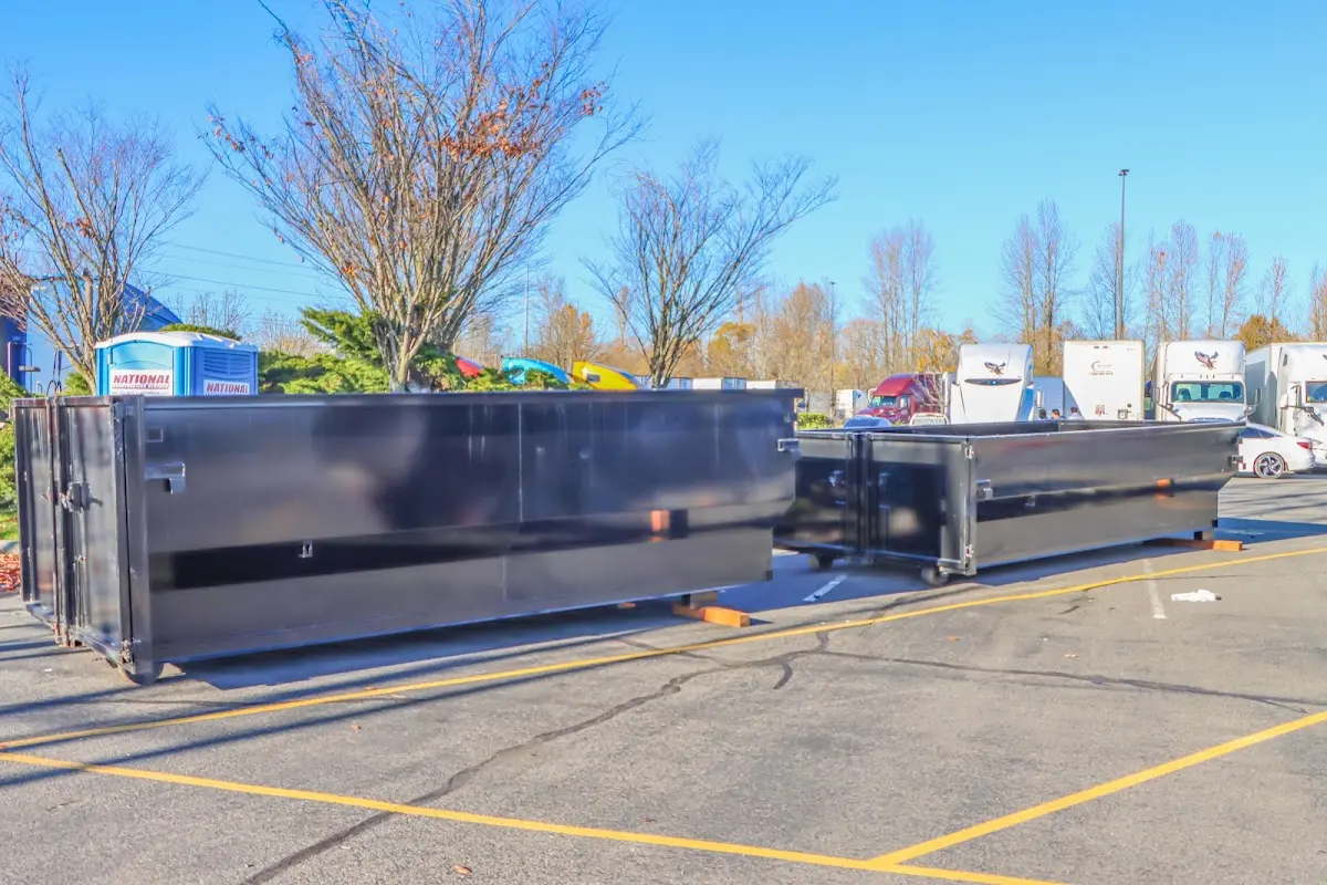 Professional dumpster rental service with roll-off container on residential driveway in Willington